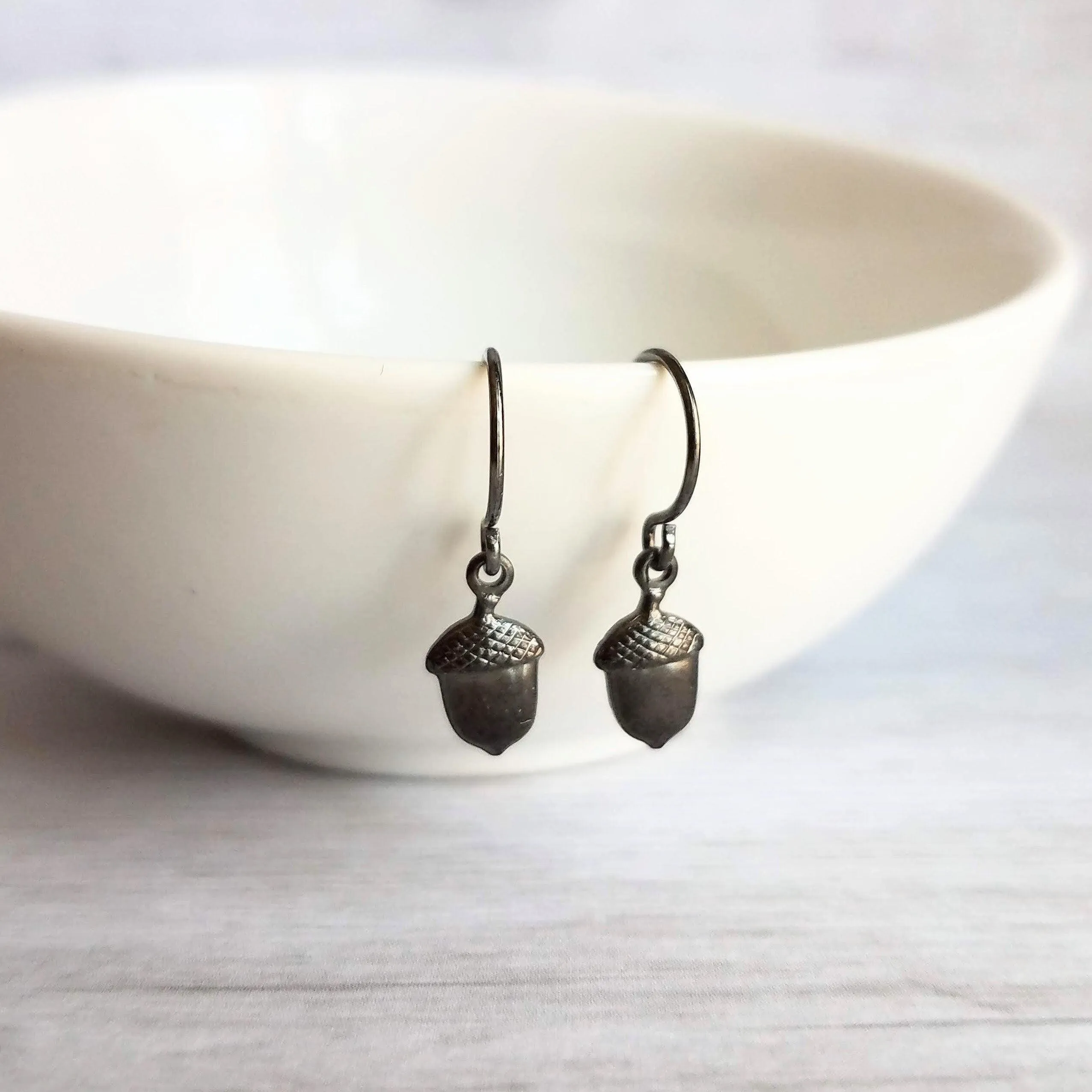 Mini Acorn Earrings - small black silver gunmetal squirrel nut charms dangle on delicate shiny little ear hooks, fall autumn jewelry