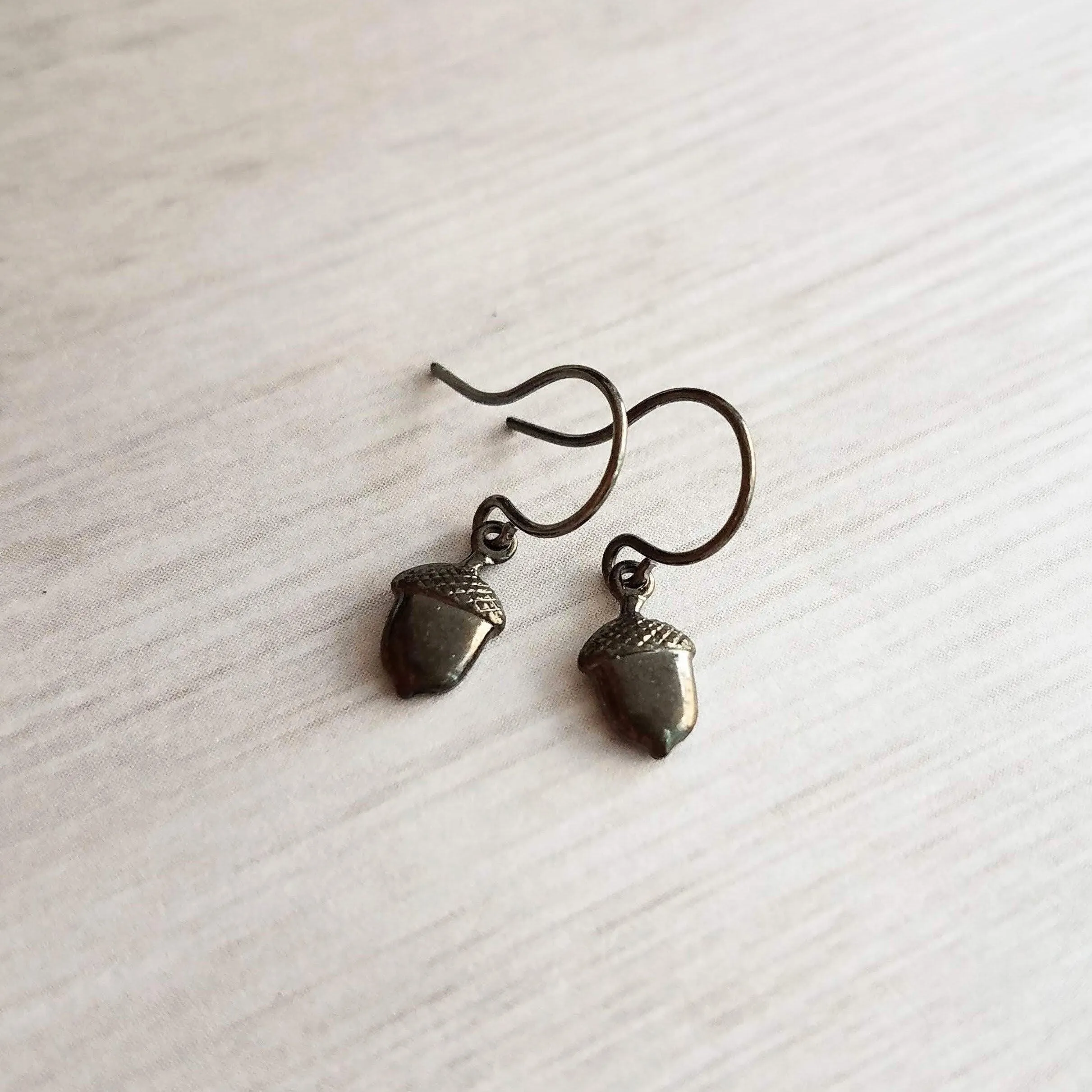 Mini Acorn Earrings - small black silver gunmetal squirrel nut charms dangle on delicate shiny little ear hooks, fall autumn jewelry