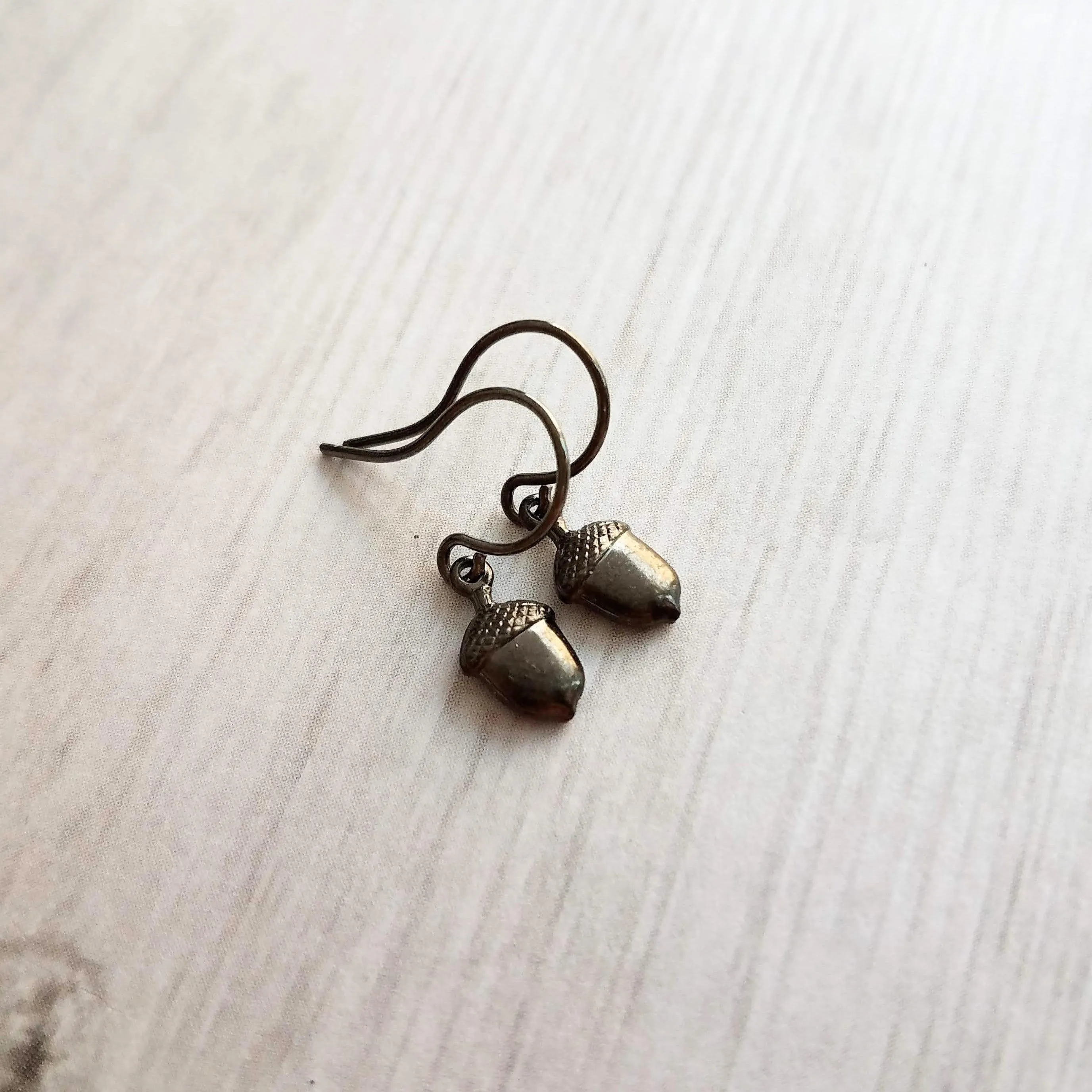 Mini Acorn Earrings - small black silver gunmetal squirrel nut charms dangle on delicate shiny little ear hooks, fall autumn jewelry