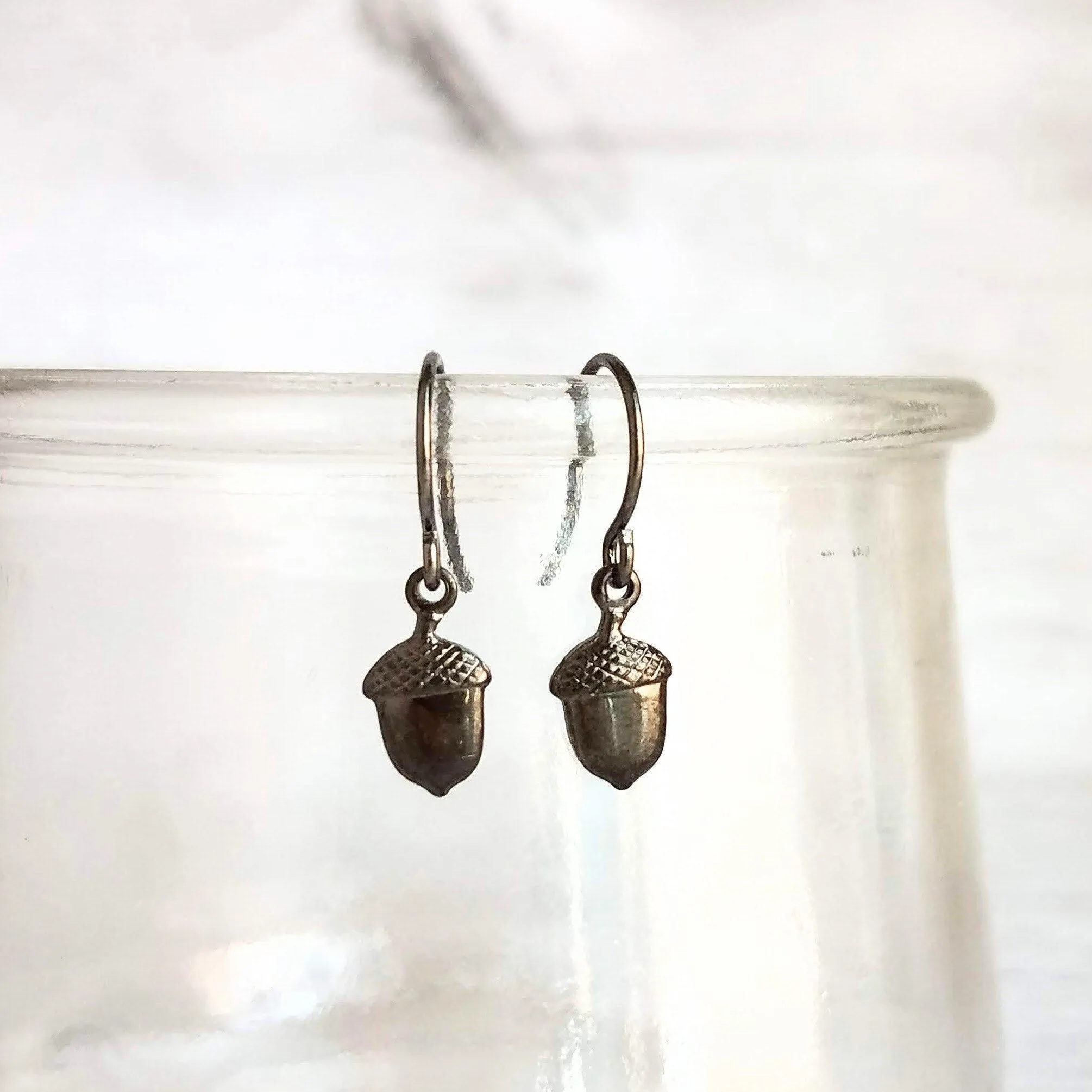 Mini Acorn Earrings - small black silver gunmetal squirrel nut charms dangle on delicate shiny little ear hooks, fall autumn jewelry