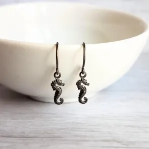 Seahorse Earrings - little tiny black gunmetal silver charms dangle on small simple shiny delicate hooks, minimalist tropical beach memento