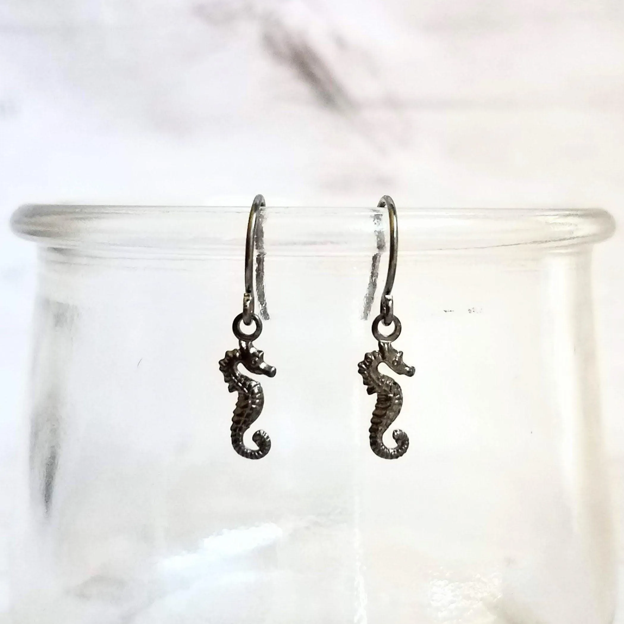 Seahorse Earrings - little tiny black gunmetal silver charms dangle on small simple shiny delicate hooks, minimalist tropical beach memento