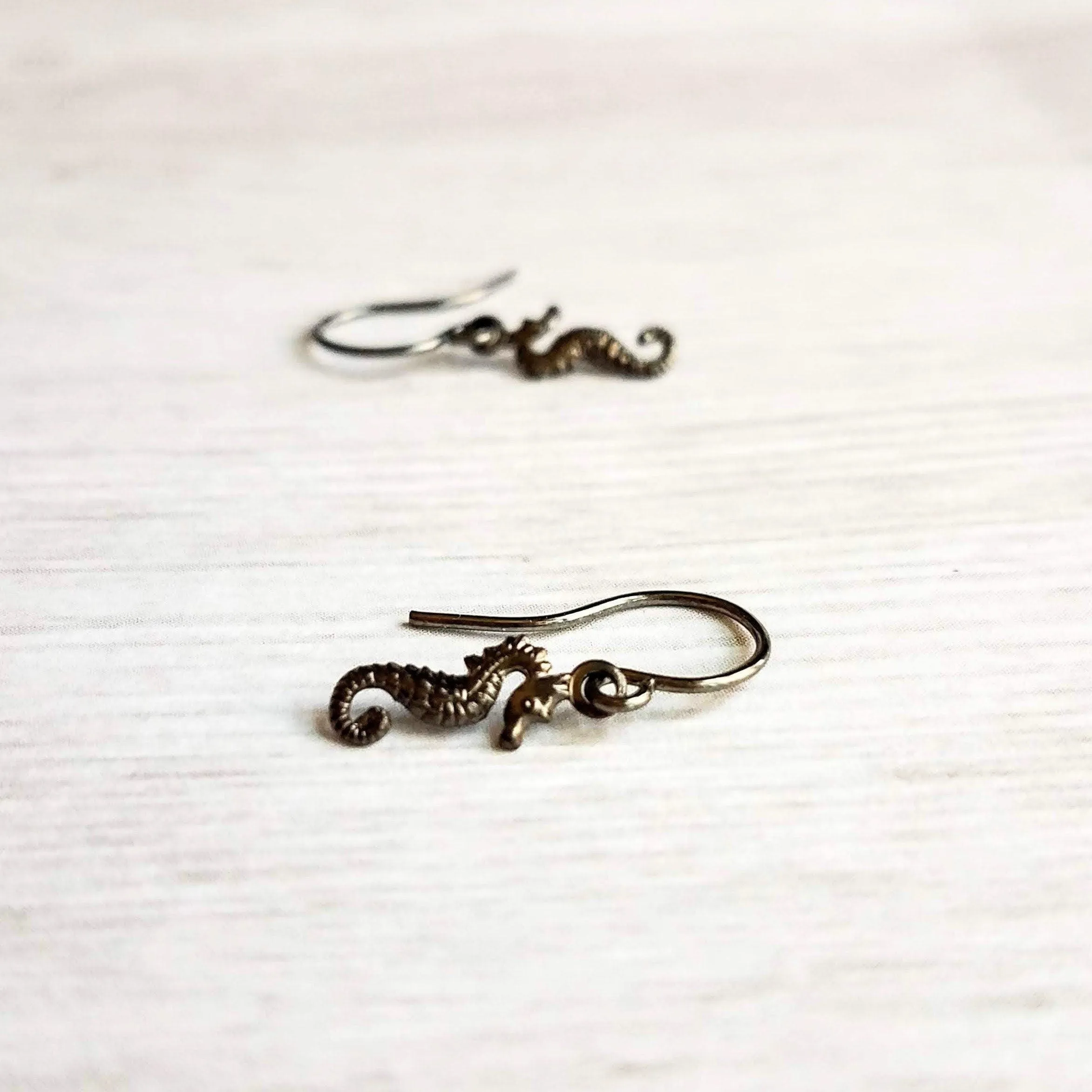 Seahorse Earrings - little tiny black gunmetal silver charms dangle on small simple shiny delicate hooks, minimalist tropical beach memento