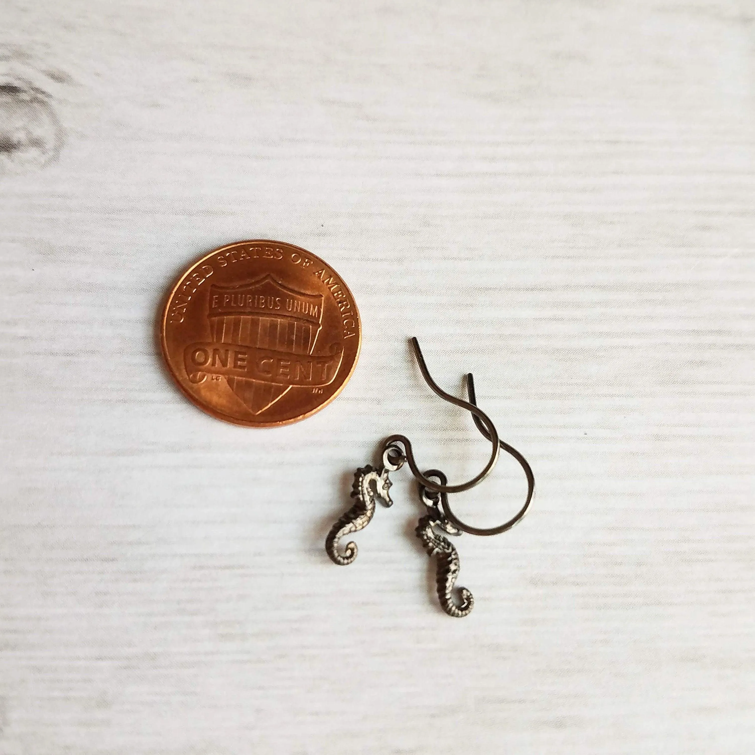 Seahorse Earrings - little tiny black gunmetal silver charms dangle on small simple shiny delicate hooks, minimalist tropical beach memento